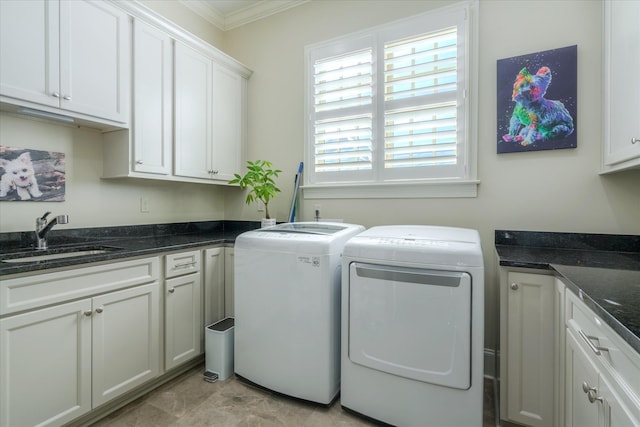 clothes washing area with cabinet space, independent washer and dryer, ornamental molding, and a sink