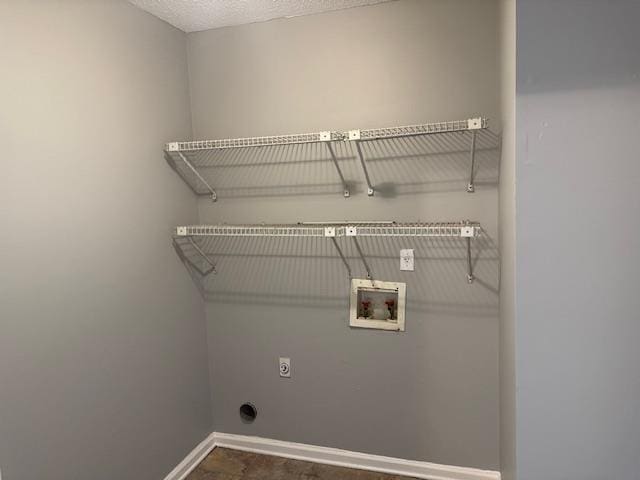 laundry room with electric dryer hookup, hookup for a washing machine, laundry area, and baseboards