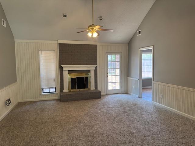 unfurnished living room with visible vents, a wainscoted wall, ceiling fan, and carpet flooring
