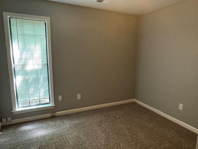 spare room with carpet flooring and baseboards