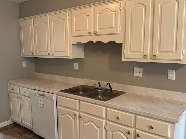 kitchen with a sink, dishwasher, white cabinetry, and light countertops