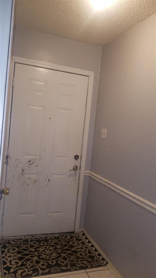 doorway to outside featuring baseboards