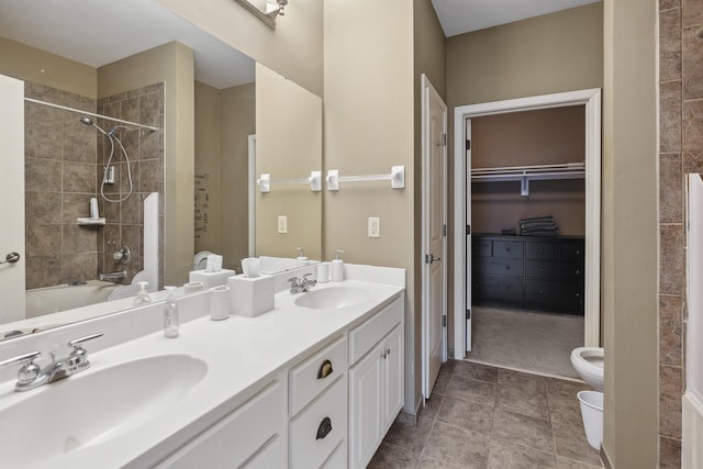 bathroom featuring bathtub / shower combination, toilet, double vanity, and a sink