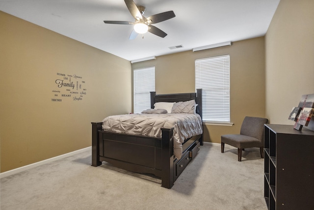 bedroom with visible vents, ceiling fan, baseboards, and light carpet