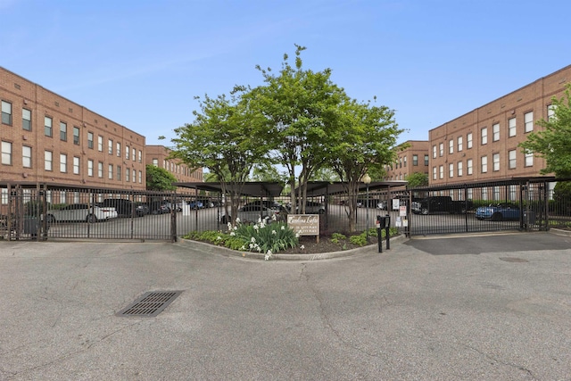 exterior space featuring a gated entry, curbs, and a gate