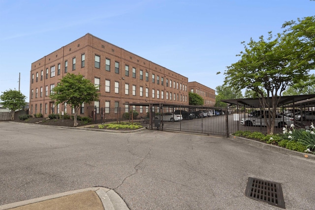 view of property featuring covered parking and fence
