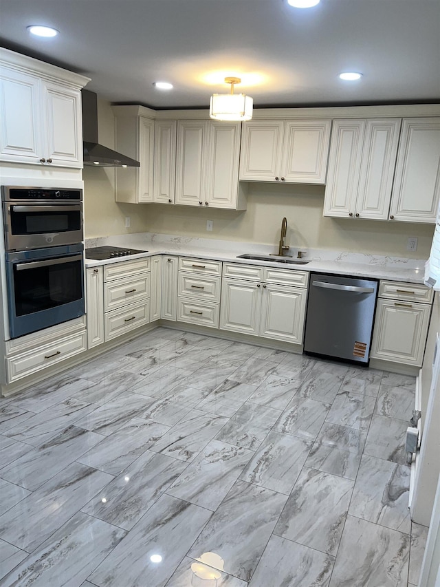 kitchen featuring appliances with stainless steel finishes, wall chimney exhaust hood, a sink, light marble finish floors, and recessed lighting