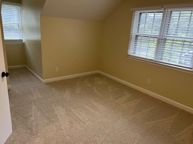 bonus room featuring carpet flooring, lofted ceiling, baseboards, and healthy amount of natural light