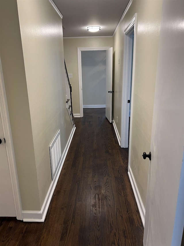 hall with wood finished floors, baseboards, ornamental molding, and stairs