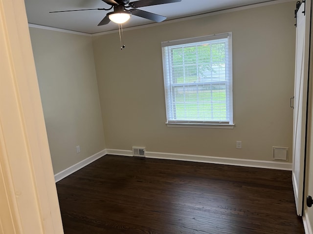 spare room with crown molding, a ceiling fan, plenty of natural light, and dark wood-type flooring