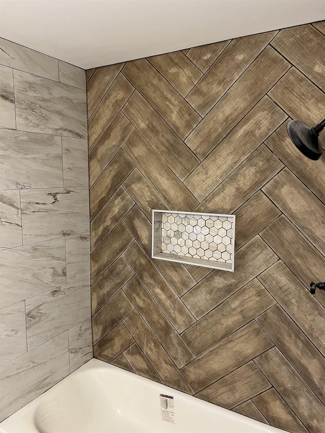 bathroom view of a bath and tiled shower