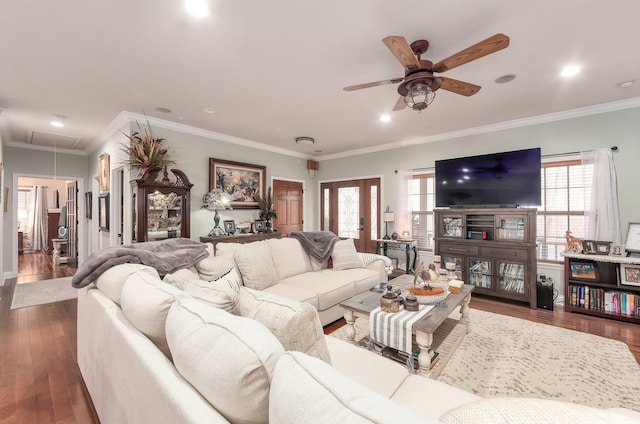 living area with dark wood-style floors, attic access, a ceiling fan, and a wealth of natural light