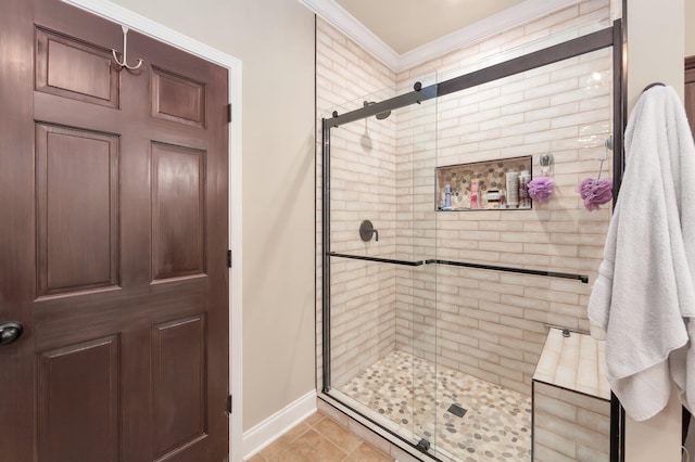 bathroom with baseboards, a stall shower, tile patterned floors, and ornamental molding
