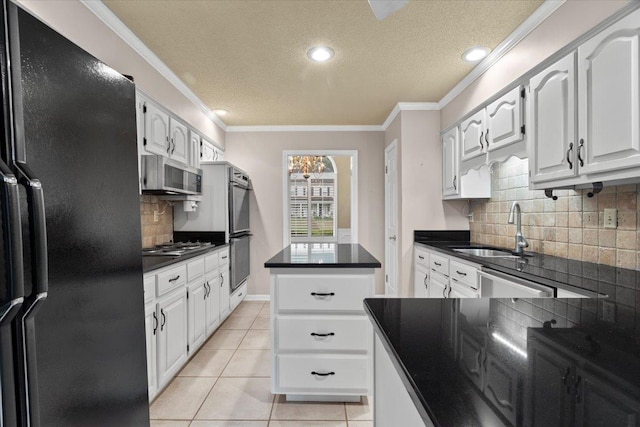 kitchen with dark countertops, a sink, stainless steel appliances, and tasteful backsplash