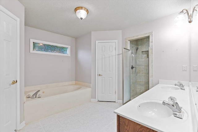 bathroom with a stall shower, a textured ceiling, a bath, and a sink
