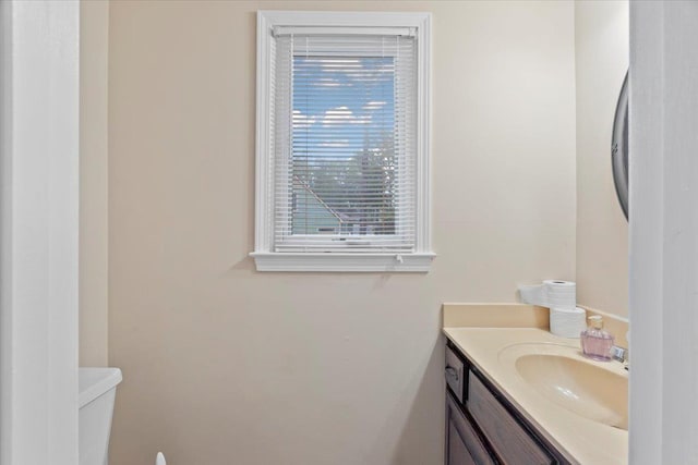 bathroom featuring toilet and vanity