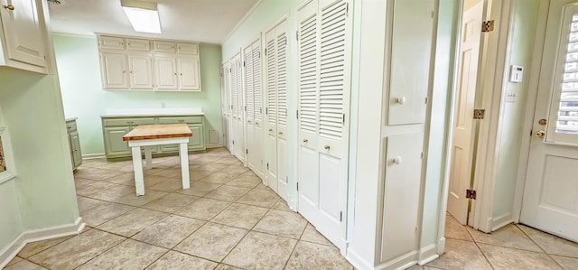 interior space featuring light tile patterned floors and baseboards