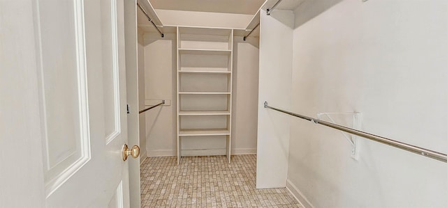 spacious closet featuring light floors