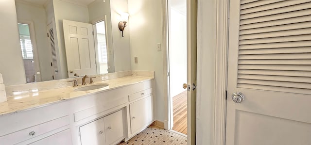bathroom with vanity and crown molding