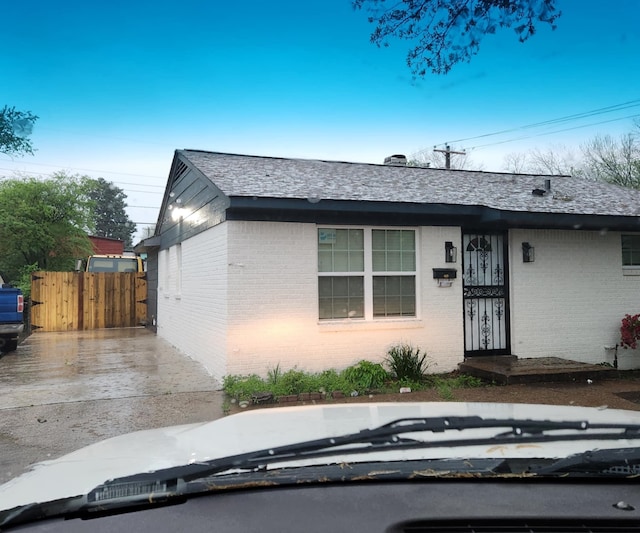 view of front of house with fence and brick siding