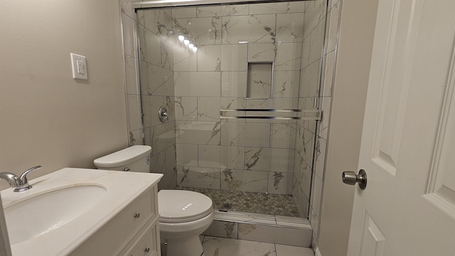 full bathroom featuring vanity, a stall shower, toilet, and marble finish floor