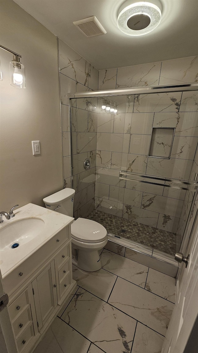 full bath featuring visible vents, vanity, marble finish floor, toilet, and a shower stall
