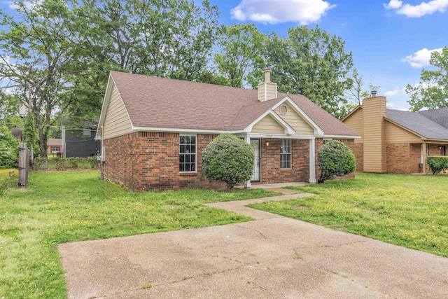 2568 Parkview Dr, Memphis, TN 38128 - view of front of property featuring a chimney, a front yard, a shingled roof, and brick siding