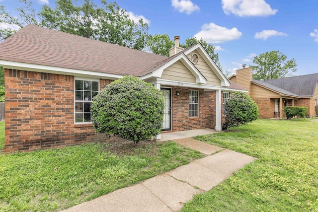 2568 Parkview Dr, Memphis, TN 38128 - view of front facade with a front lawn, a shingled roof, and brick siding