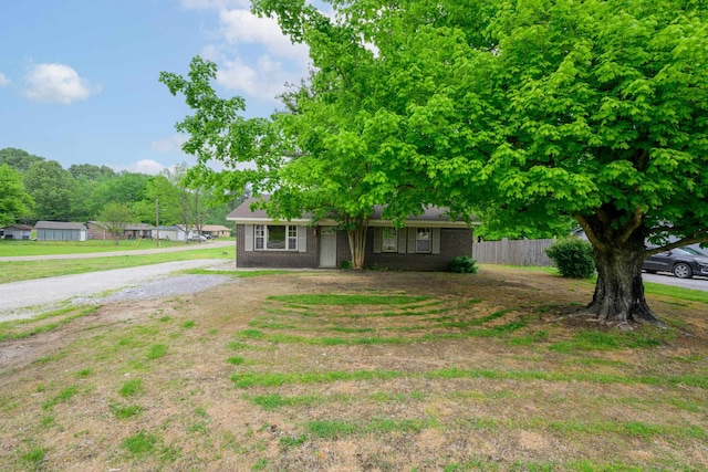 view of front of property featuring brick siding and fence