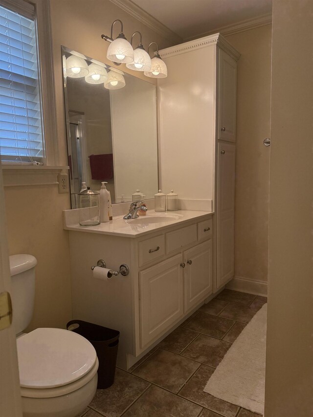 bathroom with toilet, crown molding, and vanity