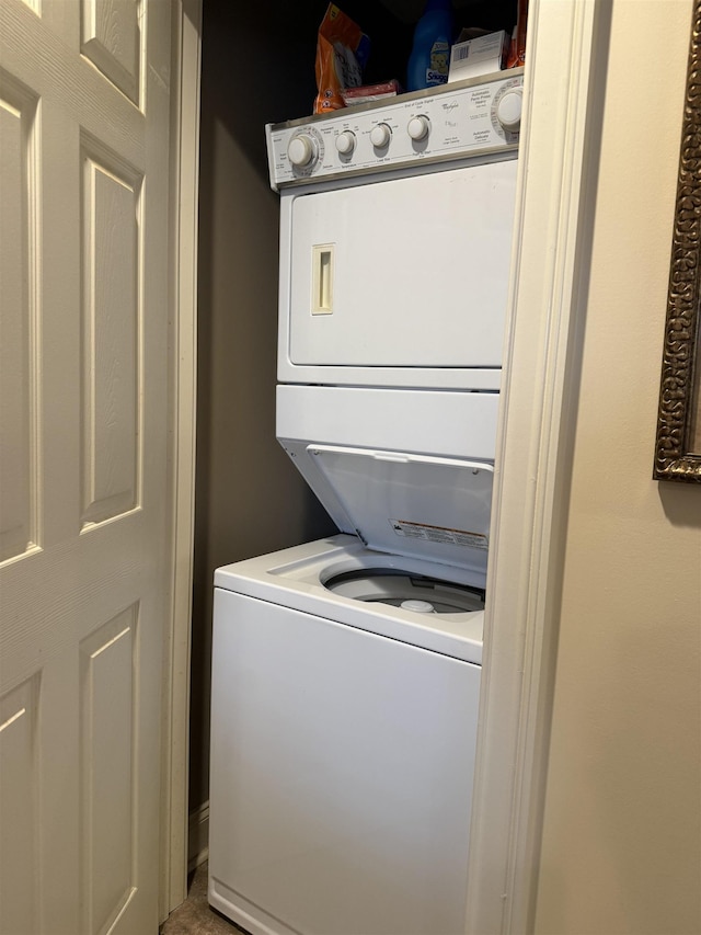 clothes washing area with stacked washer / drying machine and laundry area