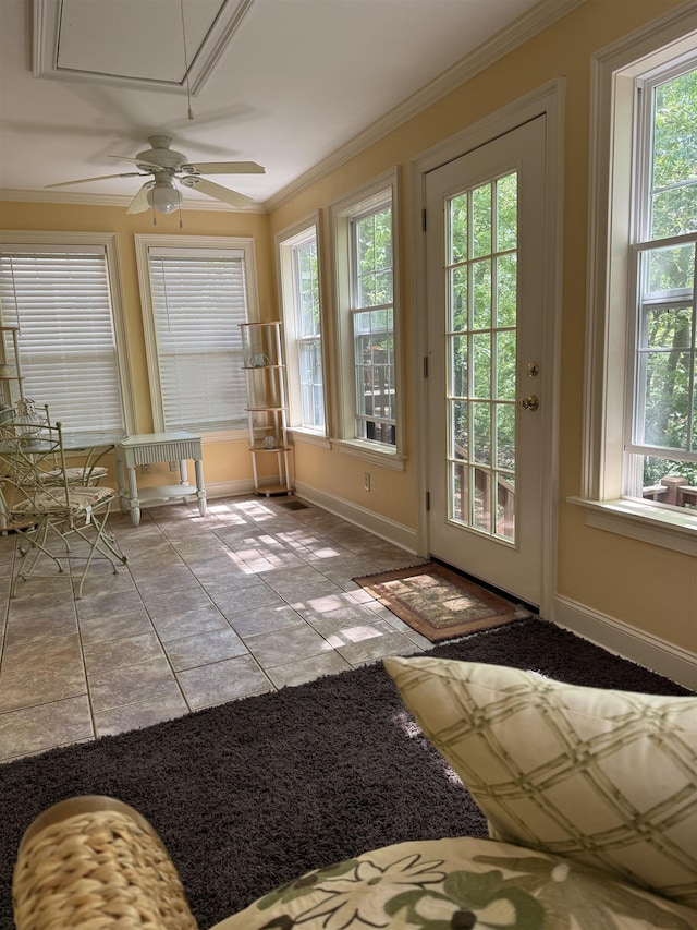 entryway featuring ceiling fan, ornamental molding, tile patterned flooring, and baseboards