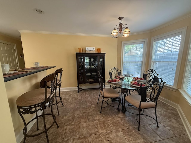 dining space with crown molding, a notable chandelier, and baseboards