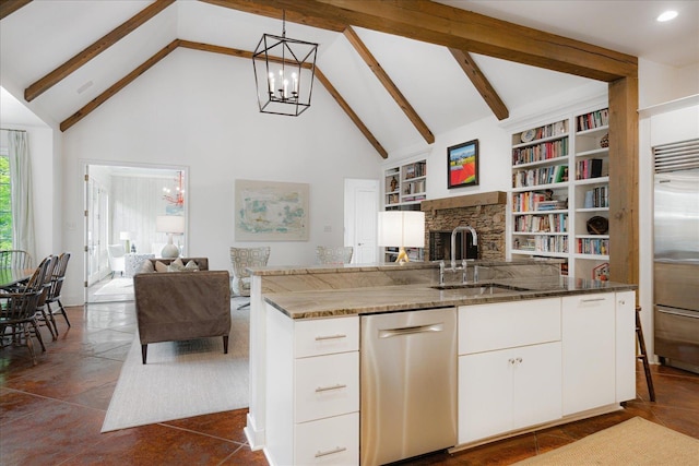 kitchen featuring a sink, a chandelier, stainless steel appliances, high vaulted ceiling, and open floor plan