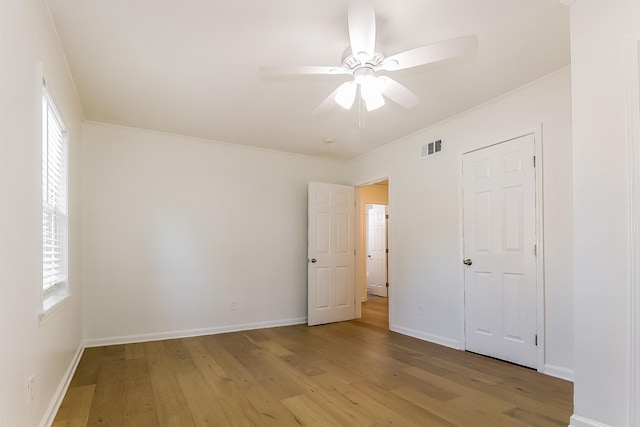 4143 Hilldale Ave, Memphis, TN 38117 - unfurnished bedroom featuring visible vents, baseboards, light wood-style flooring, and multiple windows