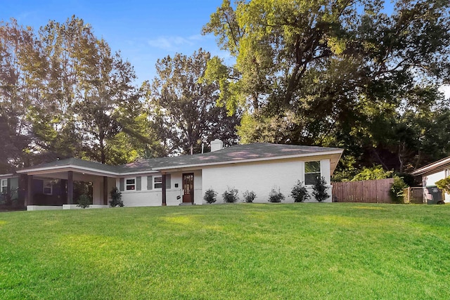 4143 Hilldale Ave, Memphis, TN 38117 - ranch-style house with an attached carport, a chimney, a front yard, fence, and brick siding