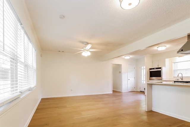 4143 Hilldale Ave, Memphis, TN 38117 - interior space featuring white cabinetry, light countertops, oven, light wood-type flooring, and a ceiling fan