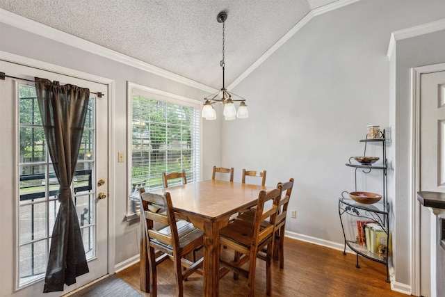 dining room featuring an inviting chandelier, dark wood-type flooring, vaulted ceiling, ornamental molding, and a textured ceiling