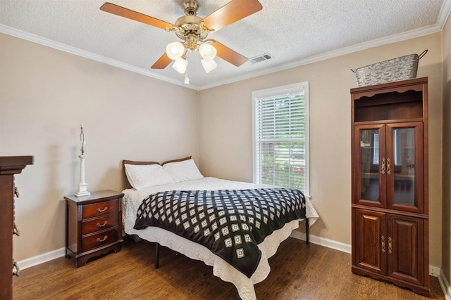bedroom featuring baseboards, visible vents, wood finished floors, and a textured ceiling