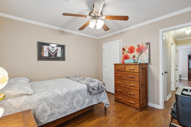 bedroom with a ceiling fan, baseboards, ornamental molding, a textured ceiling, and wood finished floors