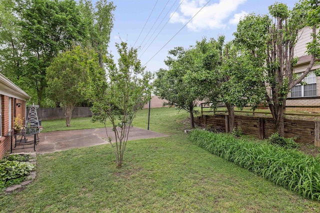 view of yard with fence and a patio