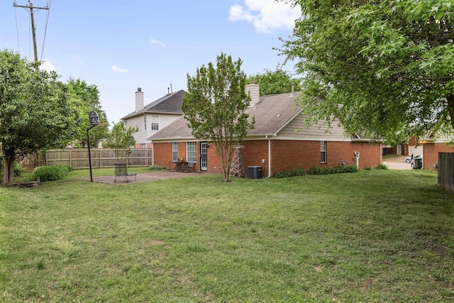 back of property with a patio, central AC unit, a lawn, brick siding, and fence