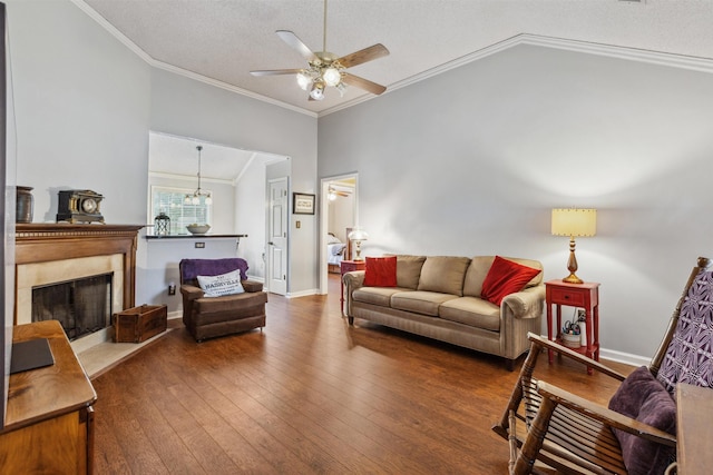 living room with wood-type flooring, crown molding, a ceiling fan, a textured ceiling, and lofted ceiling