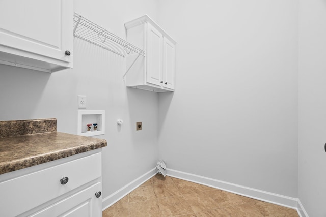 washroom featuring hookup for an electric dryer, cabinet space, washer hookup, baseboards, and gas dryer hookup