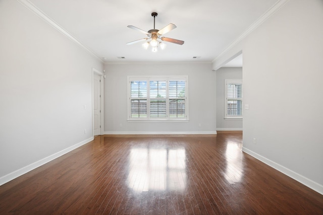 empty room featuring ornamental molding, a ceiling fan, wood finished floors, and baseboards