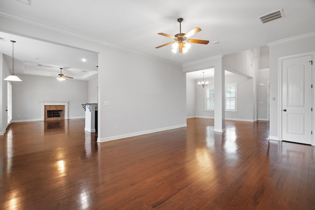 unfurnished living room with visible vents, baseboards, dark wood finished floors, a fireplace, and ceiling fan with notable chandelier