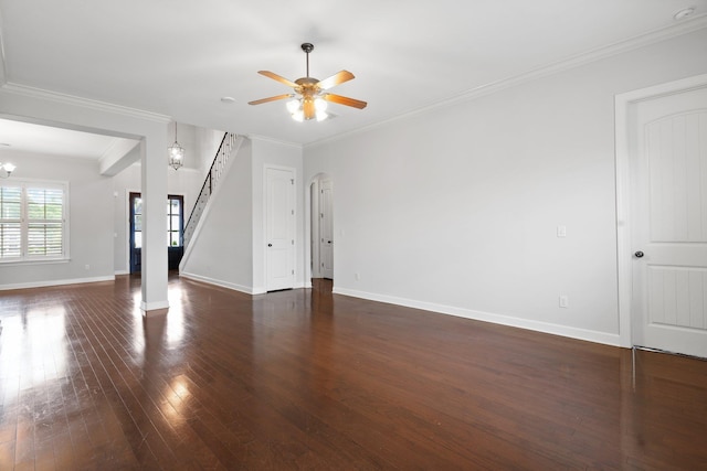 unfurnished living room with dark wood-type flooring, baseboards, stairway, a ceiling fan, and crown molding