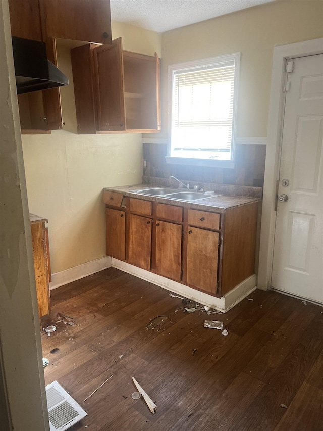 kitchen with open shelves, a sink, visible vents, dark wood-type flooring, and brown cabinetry