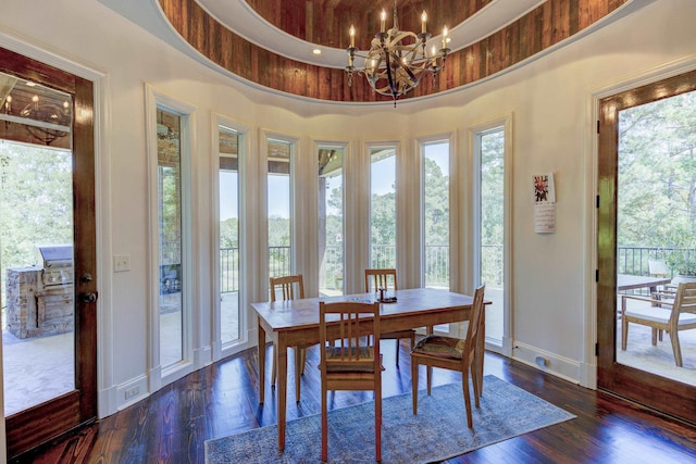 dining area with a wealth of natural light, baseboards, and a notable chandelier