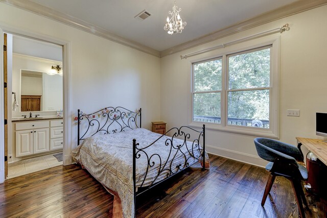 bedroom featuring visible vents, ornamental molding, an inviting chandelier, and hardwood / wood-style flooring